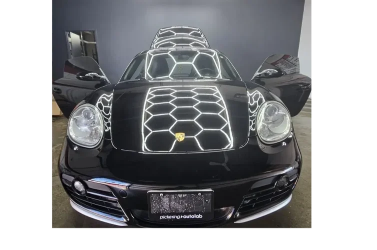 Black sports car with reflective hexagonal patterns on the hood, showcasing expert detailing and shine, representing Mr. Shine's car wash services in Pickering.